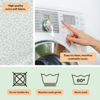 Washing machine with a hand adjusting settings, fabric texture, and washing machine symbols.