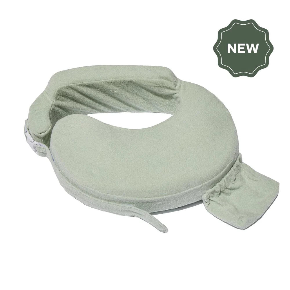 My Brest Friend nursing pillow in a soft sage green plush fabric, featuring an adjustable waist strap, backrest cushion, side pocket, and a dark green "NEW" badge overlay.