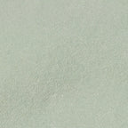 A close-up of a light grey, textured fabric surface, likely suede. The material appears soft and slightly fuzzy, conveying a sense of warmth and comfort.