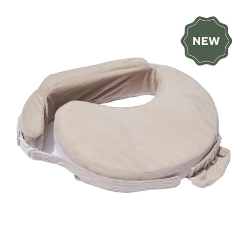 Tan-colored nursing pillow with armrests and a secure buckle, designed for comfort and support. "New" label in a dark green badge at the top right.