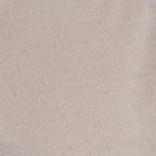 Close-up of a light beige textured surface, resembling soft fabric or suede. The subtle creases create a gentle, calming pattern.