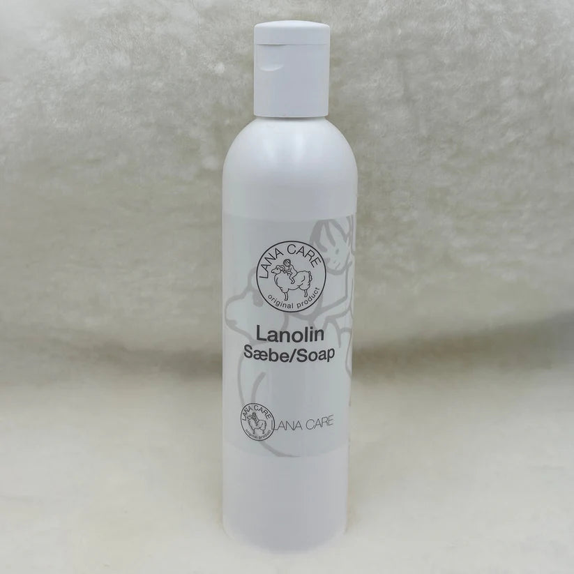 White bottle of Lanolin Soap on a textured surface