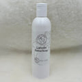 White bottle of Lanolin Soap on a textured surface