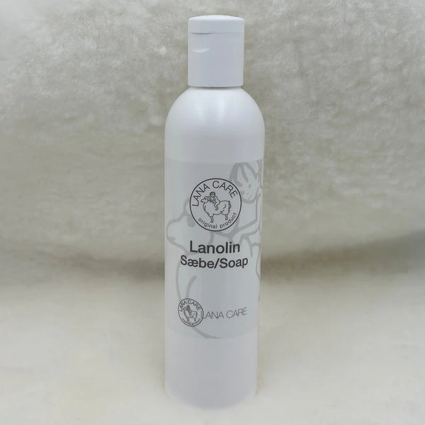White bottle of Lanolin Soap on a textured surface