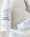 LANACare lanolin soap and cream tubes on soft beige nursing pads