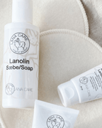 LANACare lanolin soap and cream tubes on soft beige nursing pads