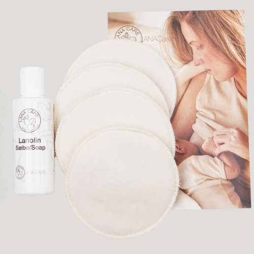 Lanolin Soap bottle with a woman holding a baby in the background