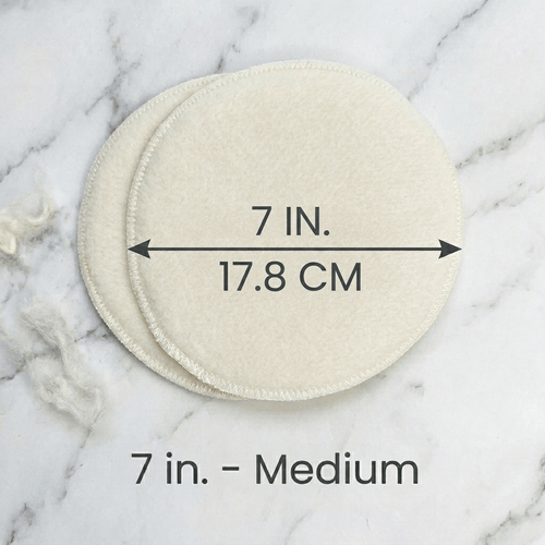 Two circular pads on a marble surface with measurements indicated.