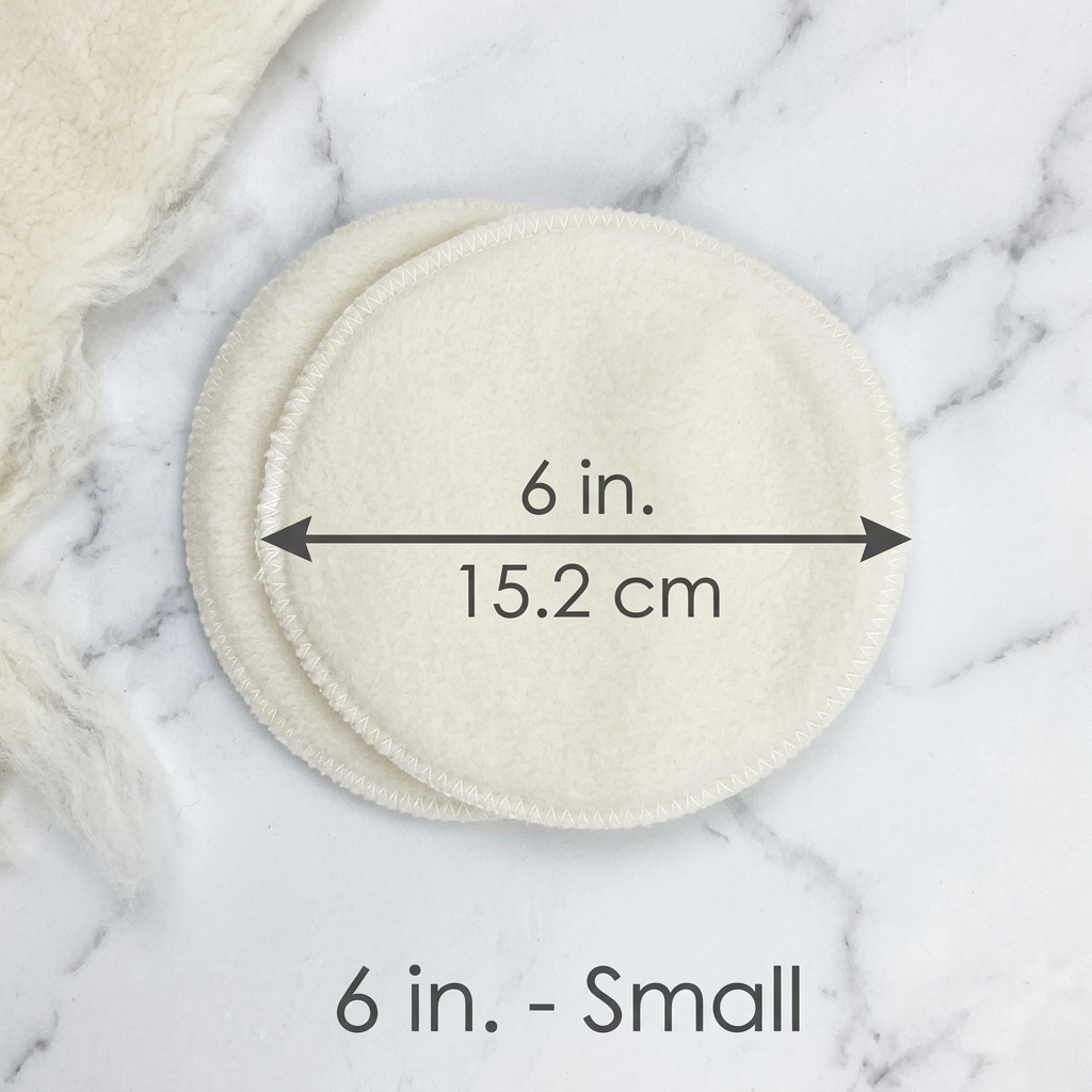 Small round cloth pads with measurement text on a marble background