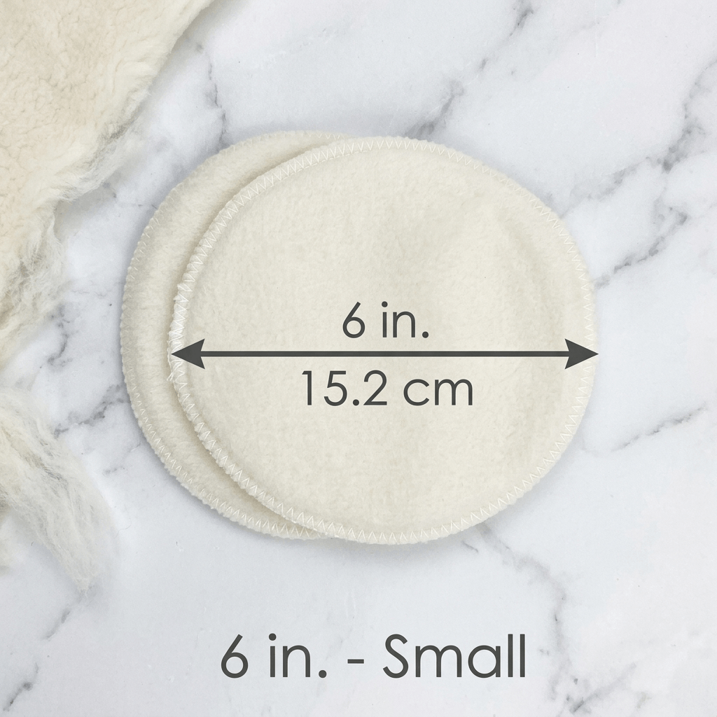 LANACare Small 6 inch wool nursing pads with measurements on a marble surface