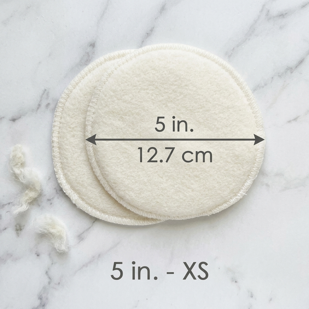 Two circular white pads on a marble surface with measurements indicated.