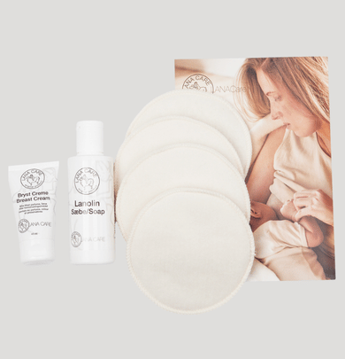 Breastfeeding pillow and bottles with a woman breastfeeding a baby on a light gray background
