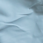 Close-up of light blue fabric with folds