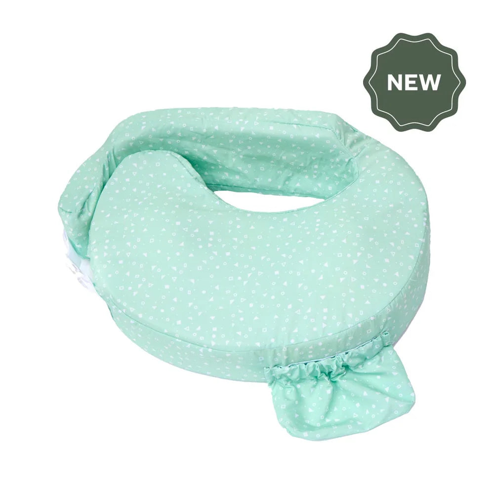 Mint green polka dot Nursing pillow with 'NEW' label on a white background
