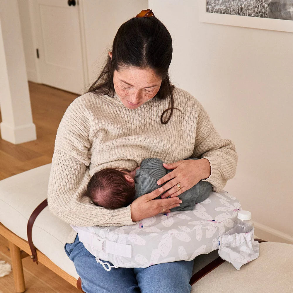 Woman breastfeeding a baby in a home setting